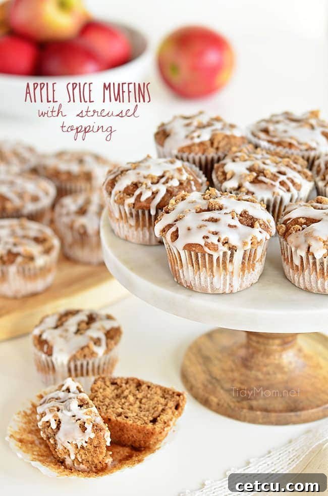 Delicious Apple Spice Muffins with Streusel Topping on a elegant cake stand, ready to be enjoyed as a fall breakfast treat.