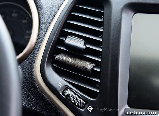 Freshening up car interior with an air freshener after cleaning.