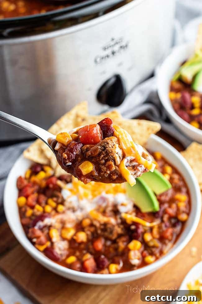 A close-up shot of a spoonful of slow cooker taco soup, highlighting the rich texture and ingredients.
