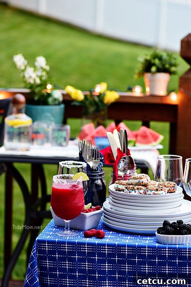 A refreshing frozen raspberry margarita garnished with lime, ideal for summer gatherings.