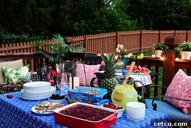 A spread of delicious food and drinks on an outdoor table, perfect for a summer BBQ.