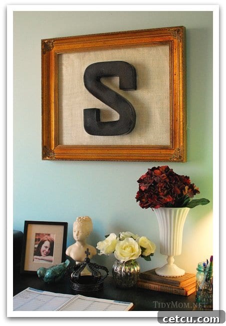 Stylish DIY wall art made from a repurposed frame, burlap backing, and a painted paper mache letter, perfect for a home office