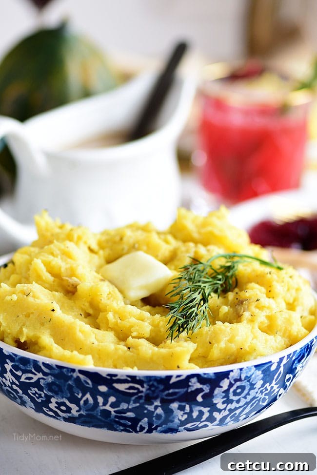 A serving bowl filled with creamy Acorn Squash Mashed Potatoes, garnished with fresh herbs, ready to be enjoyed as a festive side dish.