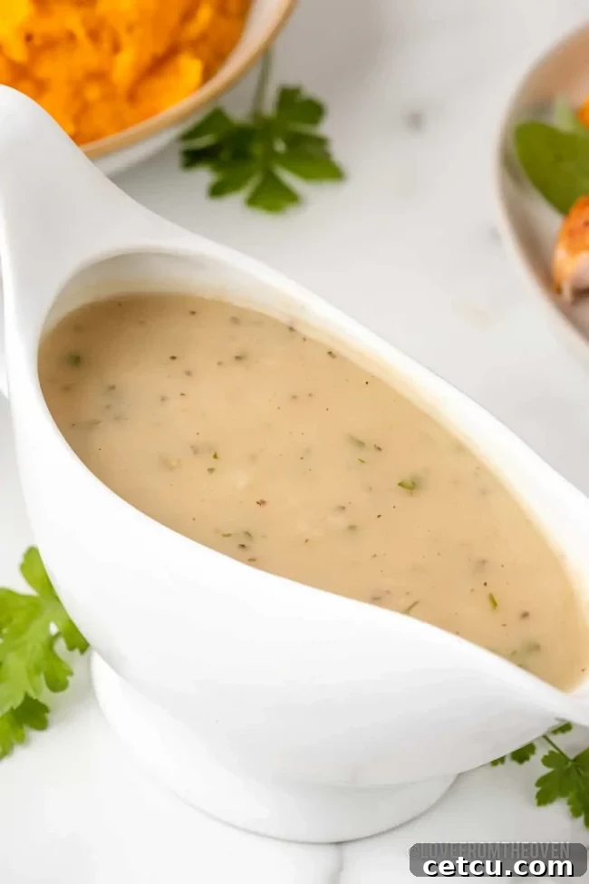 A bowl of rich, homemade Turkey Gravy, smooth and perfectly seasoned, ready to accompany a Thanksgiving meal.