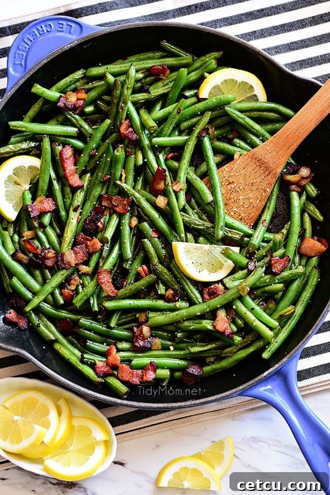 Fresh Sautéed Green Beans with crispy bacon and garlic in a blue skillet, ready to be served as a flavorful side dish.