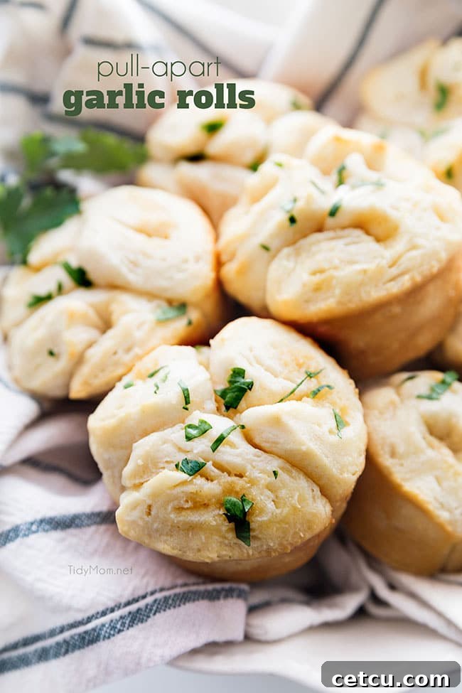 A tray of golden-brown Pull-Apart Garlic Rolls, fresh from the oven, showcasing their flaky texture and buttery sheen.