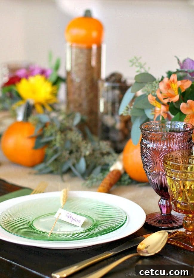 An elegant Thanksgiving table setting from Celebrations at Home, featuring beautiful plates, glassware, and fall-themed decor.