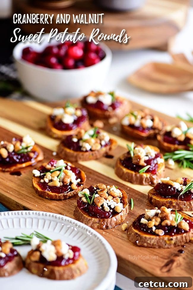 Cranberry Walnut Sweet Potato Rounds artfully arranged on a wooden tray, garnished with fresh herbs, highlighting a delicious Thanksgiving appetizer.