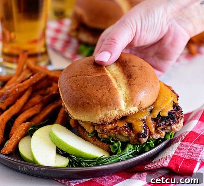 A beautifully composed photo of Apple Cheddar Pork Burgers, highlighting their delicious and fresh appeal.