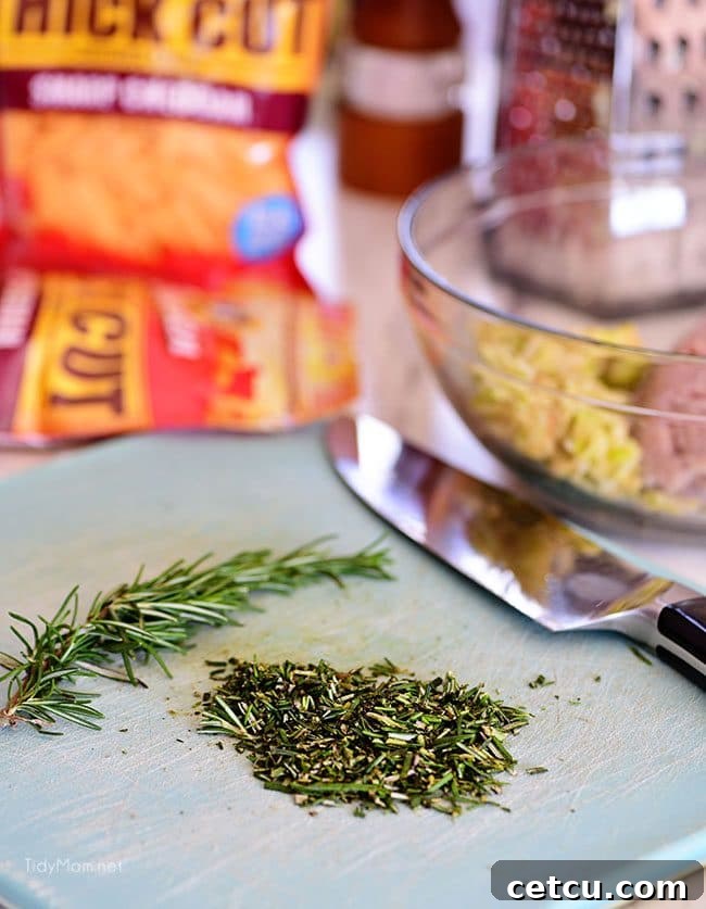 Freshly chopped rosemary, an aromatic herb, adds an earthy and fragrant note to the Apple Cheddar Pork Burgers, pairing wonderfully with pork and apples.