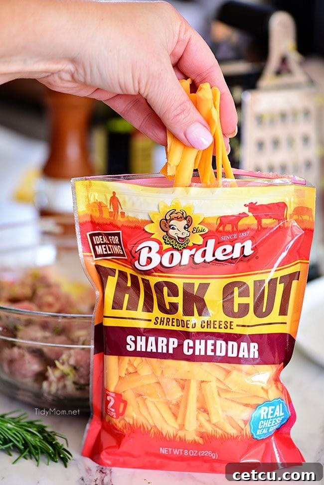 Borden Thick Cut Shredded Cheese, specifically Sharp Cheddar, enhancing Apple Cheddar Pork Burgers with its superior melting qualities and rich taste.