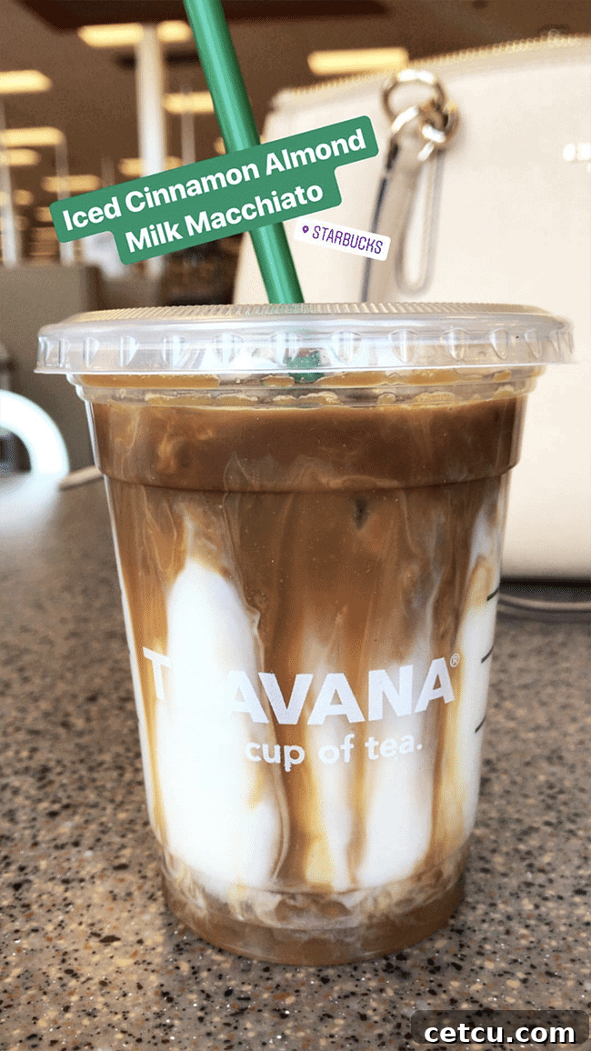 A refreshing Iced Cinnamon Almond Milk Macchiato from Starbucks, perfect for a warm spring day. Learn what to order for a delightful coffee experience.
