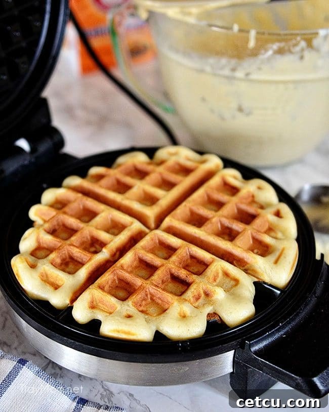 A perfectly cooked, golden brown waffle ready to be topped, illustrating the ideal texture for homemade waffles.