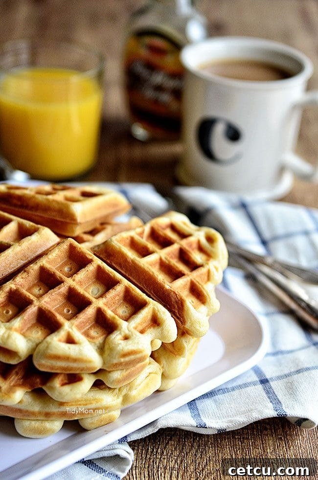 A close-up shot of classic buttermilk waffles, showcasing their golden brown color and deep pockets perfect for syrup and toppings.