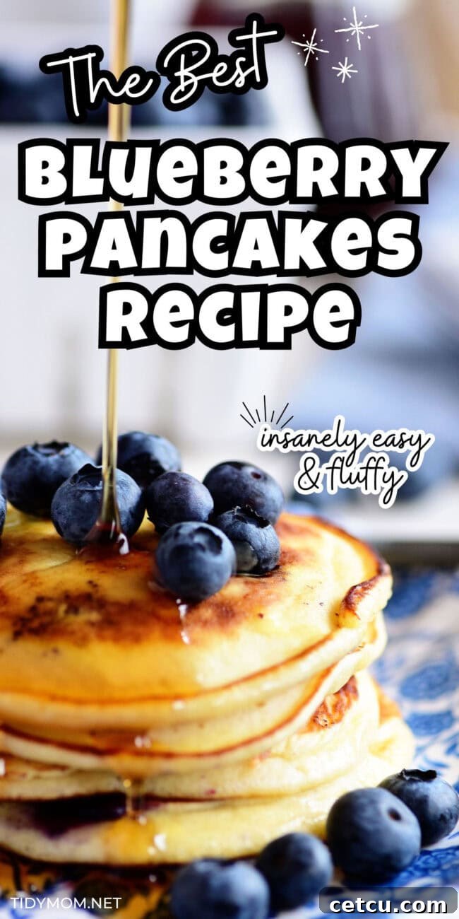 A close-up shot of golden maple syrup being generously poured over a delectable stack of fluffy blueberry pancakes, highlighting their rich texture and plump berries.