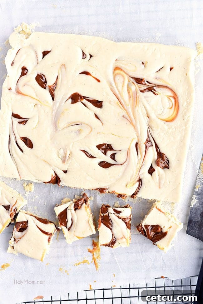 Baileys Fudge squares arranged neatly on parchment paper, showing the caramel marbling.
