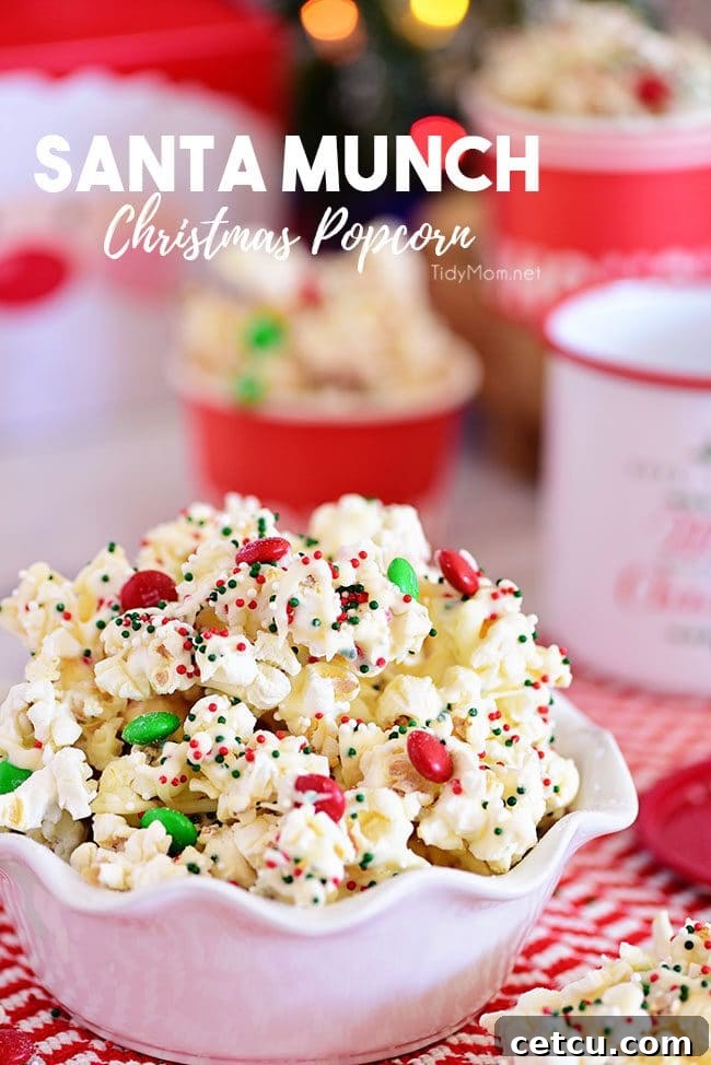 A large bowl filled to the brim with festive Santa Munch Christmas Popcorn, showcasing the white chocolate coating, colorful M&Ms, and holiday sprinkles.