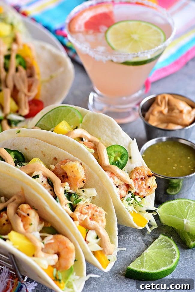 A plate of Baja Shrimp Tacos paired with a refreshing paloma cocktail