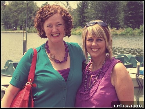 Bridget and Cheryl smiling warmly together, celebrating their reunion and sharing a joyful moment.