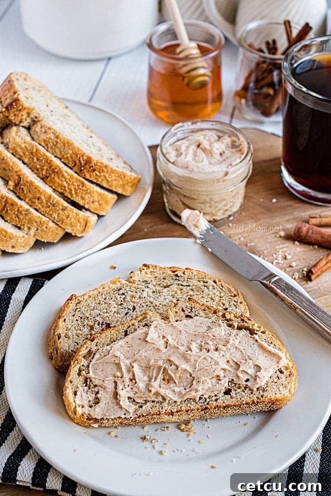 Warm, soft bread spread generously with homemade cinnamon honey butter, glistening and inviting.