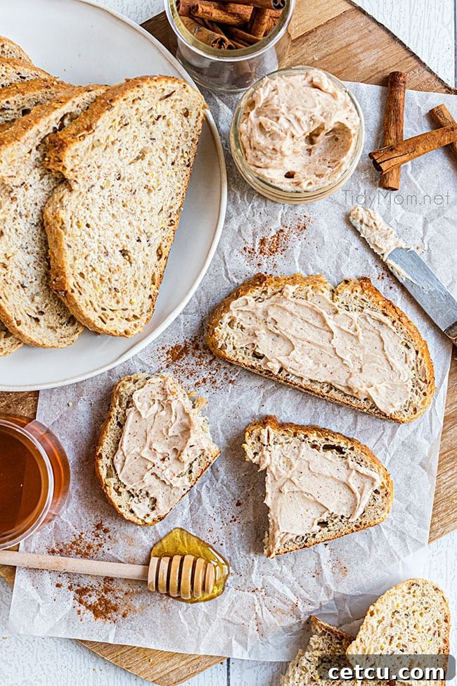 Two slices of bread generously topped with homemade cinnamon honey butter, garnished with a sprinkle of cinnamon.