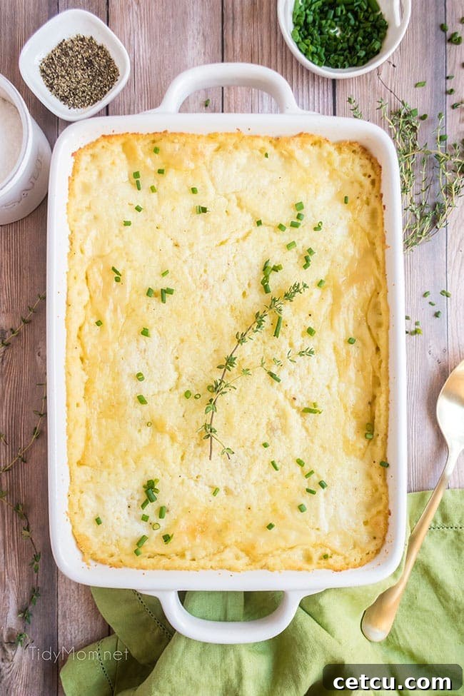 Prep-Ahead Perfection Mashed Potatoes 6 make ahead mashed potatoes in a white serving dish with a spoonful taken out