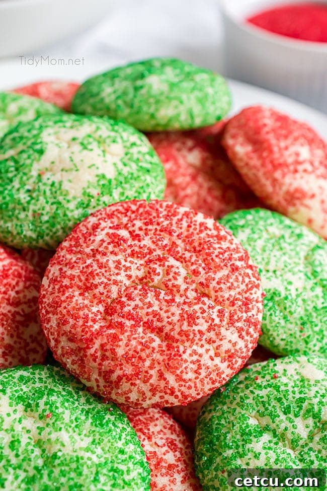 A charming pile of freshly baked red and green Christmas drop sugar cookies, showcasing their festive sanding sugar coating.