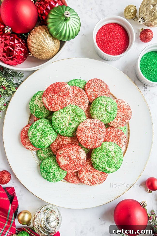 A bountiful pile of red and green Christmas drop cookies artfully arranged on a pristine white platter, highlighting their festive appearance.