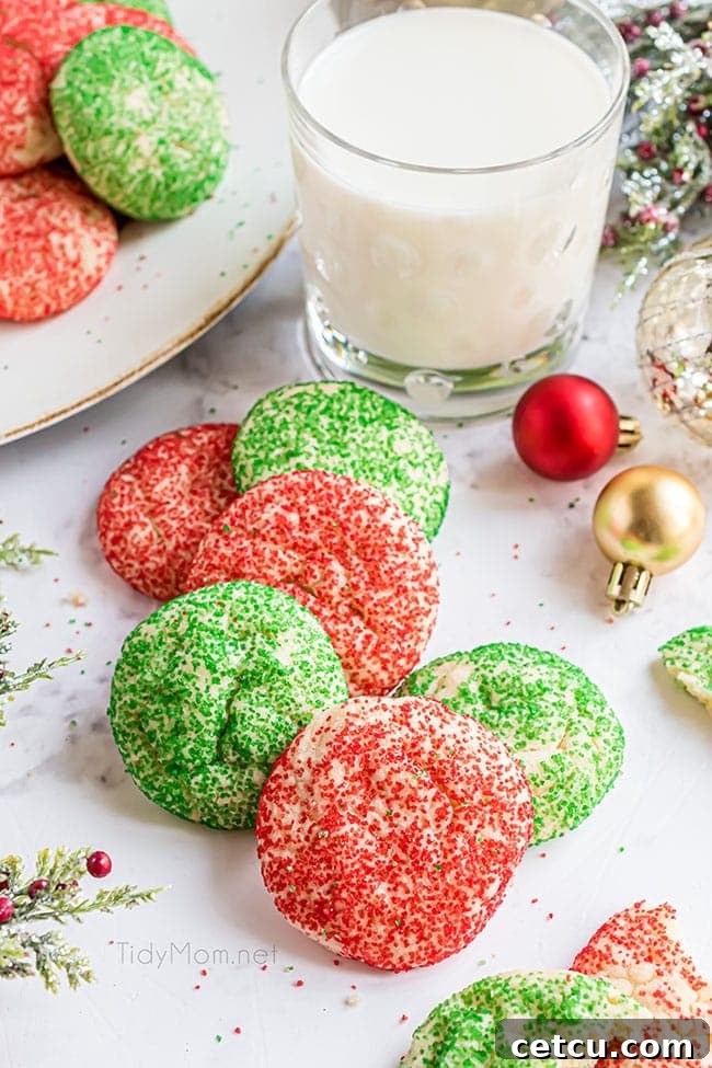 Festive Christmas drop sugar cookies arranged on a kitchen counter, accompanied by a refreshing glass of milk, inviting a classic holiday treat moment.