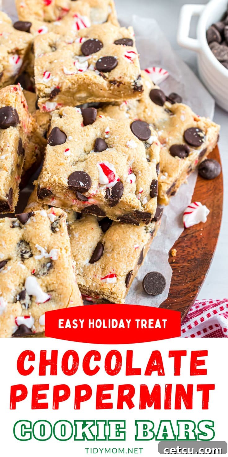 Stacked chocolate chip cookie bars on a red platter, garnished with peppermint pieces and chocolate chips.