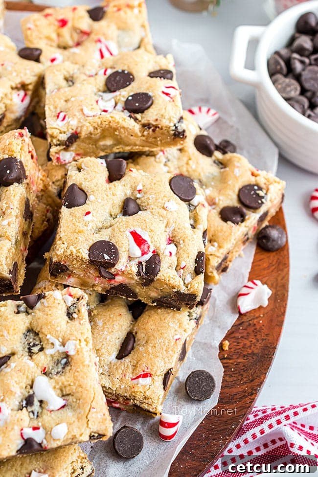 A festive platter piled high with delicious Dark Chocolate Chip Peppermint Cookie Bars, ready to be served at a holiday gathering.
