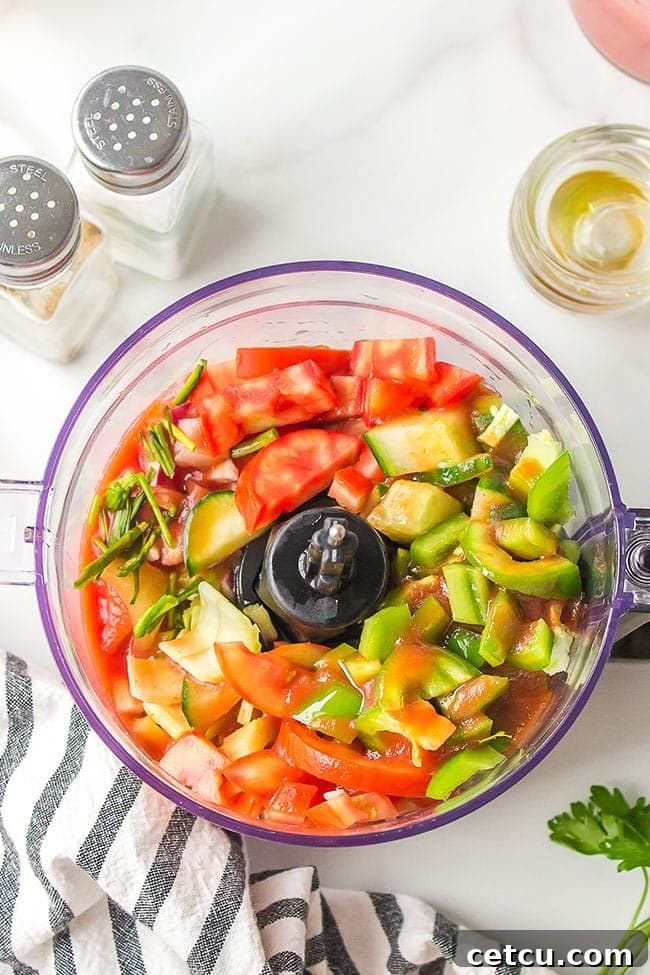fresh summer veggies in a food processor for gazpacho