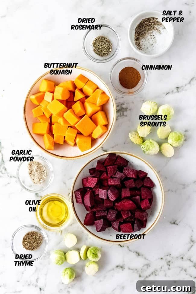 A selection of fresh ingredients for roasted fall root vegetables, including whole Brussels sprouts, a butternut squash, and beets, ready for preparation.