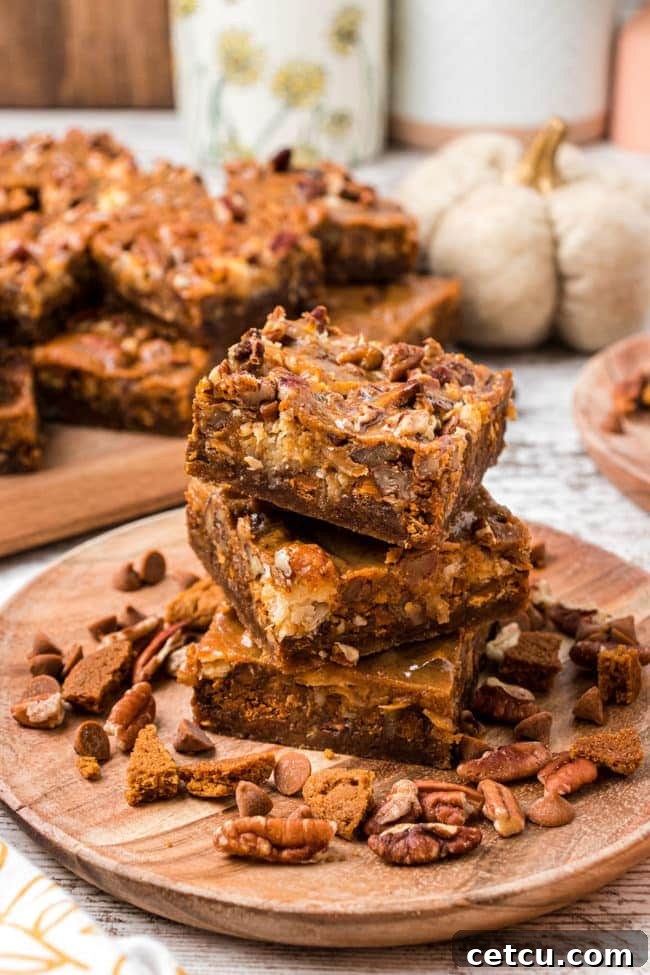 Autumn's Magical Seven Layer Pumpkin Bars 8 stack of pumpkin cookie bars, showing off their delicious layers