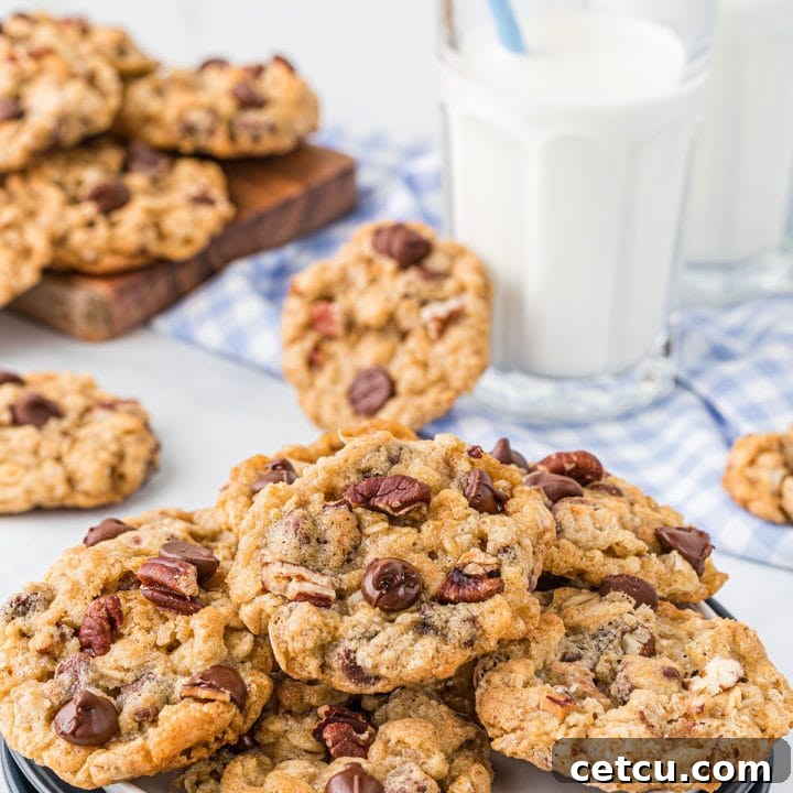 a plate full of cookies with a glass of milk and a straw.