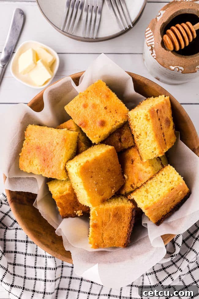 A charming basket filled with beautifully cut servings of Jiffy cornbread, ready to be enjoyed.