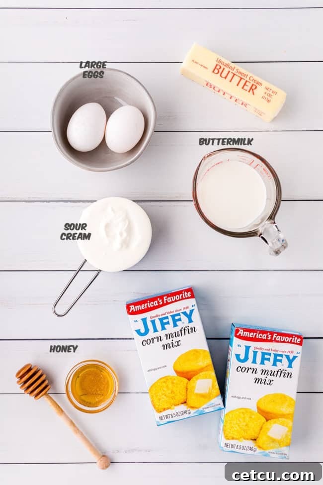 A simple array of ingredients for making light and fluffy cornbread: Jiffy mix, eggs, butter, buttermilk, honey, and sour cream.