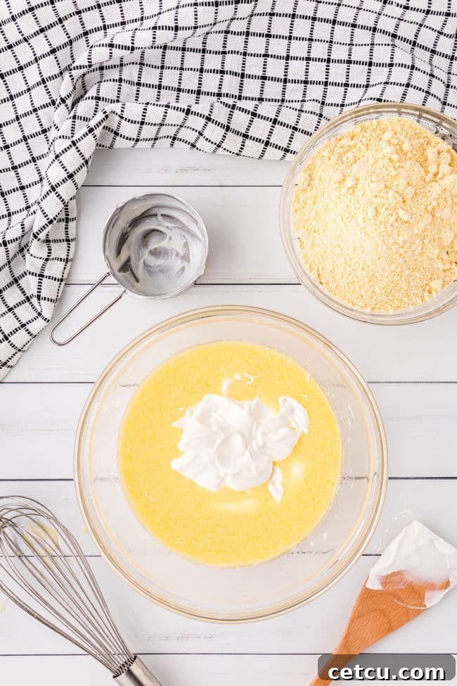 Step 1: Whisking wet ingredients for cornbread in a mixing bowl.