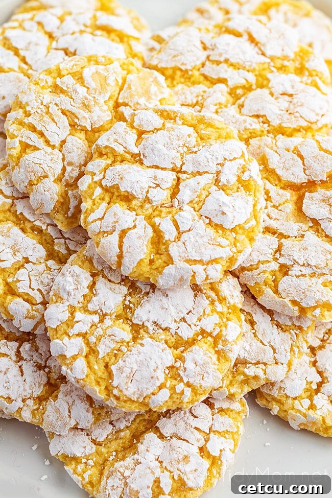 Close-up of lemon cool whip cookies piled on a kitchen counter