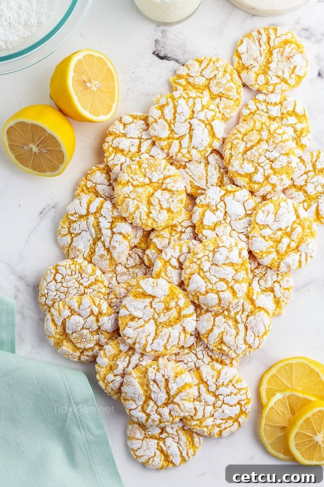 Lemon cool whip cookies scattered on a kitchen counter