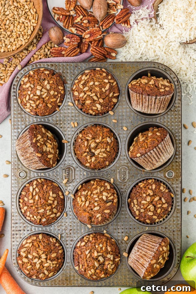 morning glory muffins with sunflower seeds in a muffin pan