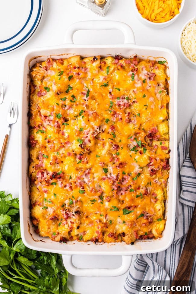A delicious English Muffin Breakfast Casserole with ham, egg, and cheese in a white baking dish, perfect for brunch or a lazy Sunday.
