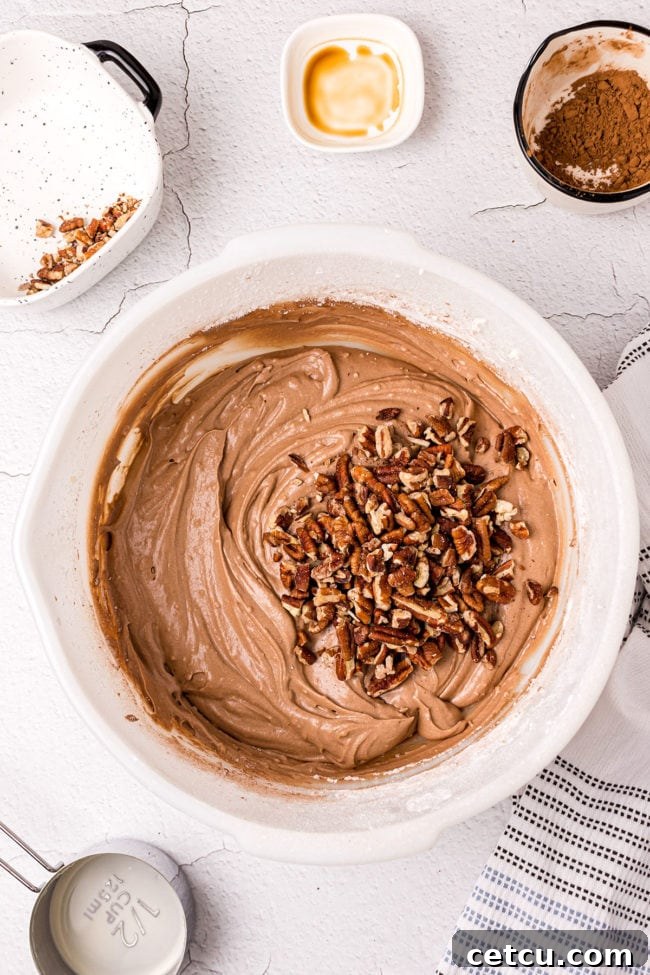 Step 11: Mixing the chocolate frosting until it's smooth, creamy, and evenly colored.