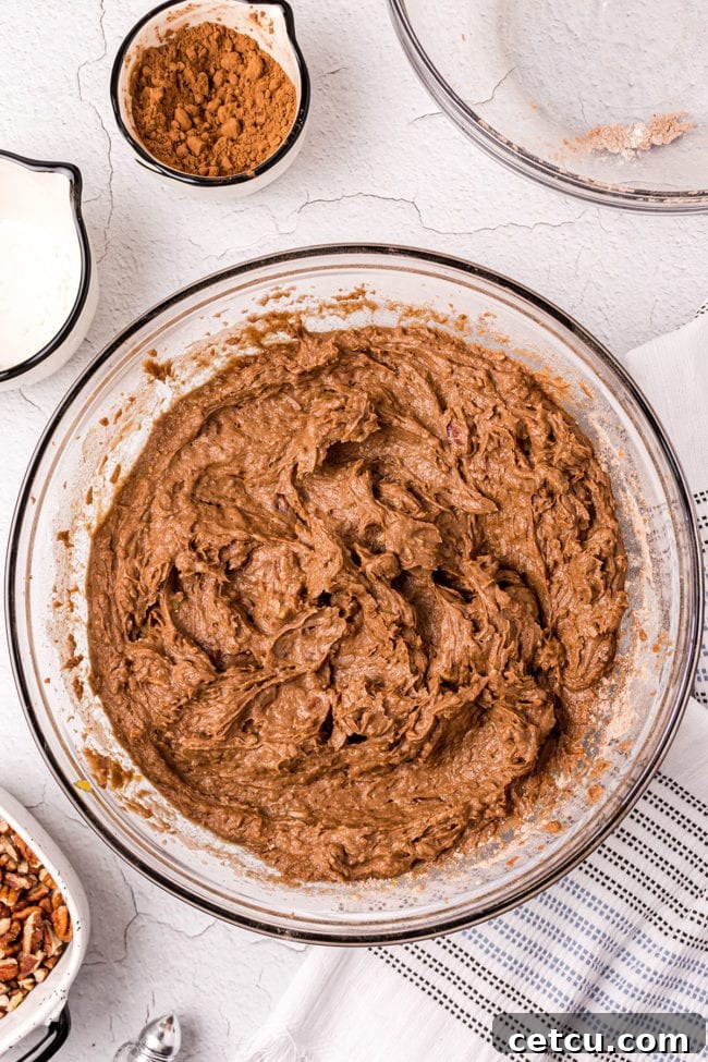 Step 5: Pouring the rich chocolate mud cake batter into a prepared baking dish.