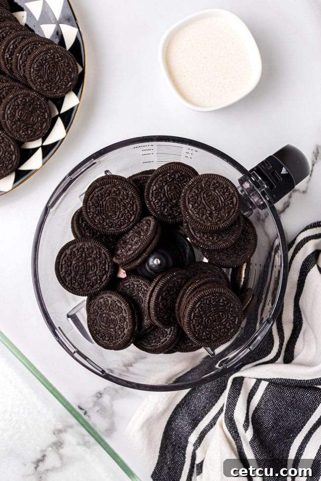 Step 1: Crushing Oreo cookies for the crust of the No-Bake Oreo Delight.