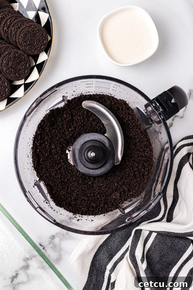 Step 2: Mixing crushed Oreos with melted butter to form the crust.