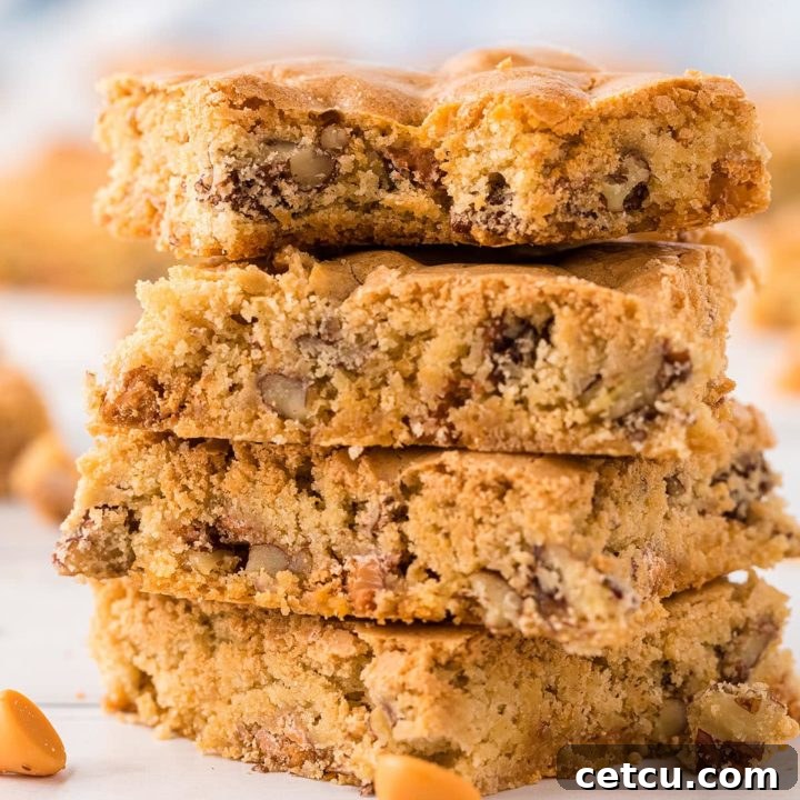 A stack of four golden-brown butterscotch blondies, rich in flavor and texture.