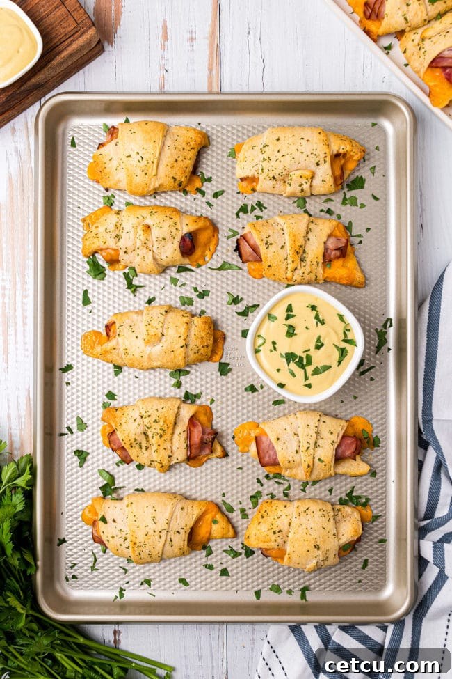 Baked Crescent Roll Sandwiches on a baking sheet, golden brown and delicious.