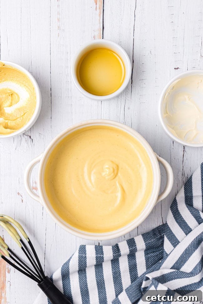 Step 8: Freshly made homemade honey mustard sauce in a small white bowl.