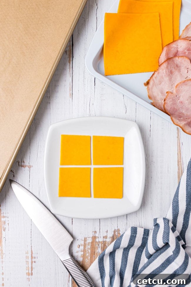 Step 2: Cutting cheese slices into smaller squares for filling.